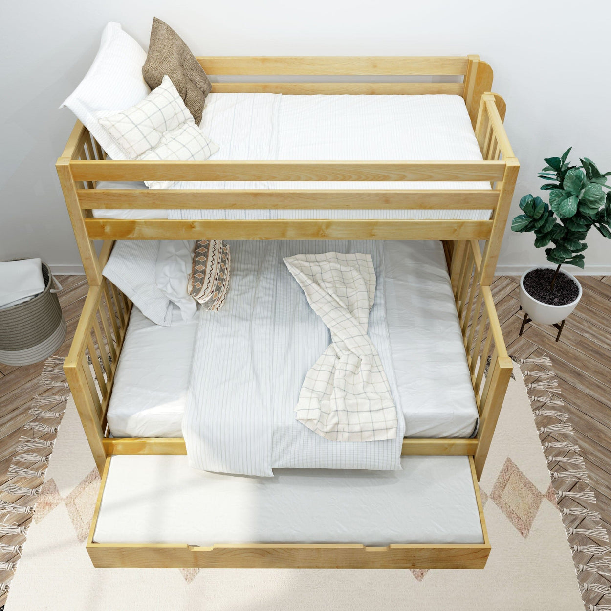 Wooden bunk bed with trundle — twin-over-full natural pine frame, white striped bedding and decorative pillows in a space-saving kids bedroom with potted plant, woven basket and neutral rug
