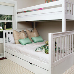 White wooden bunk bed with trundle in kids' bedroom, lower bed styled with beige and mint green decorative pillows and plush sea turtle toys