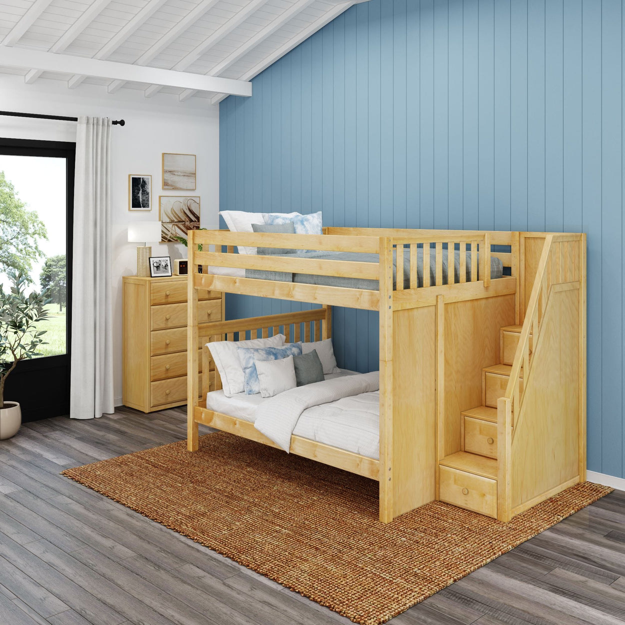 Wooden bunk bed with storage stairs in a modern bedroom featuring a blue accent wall and natural light.
