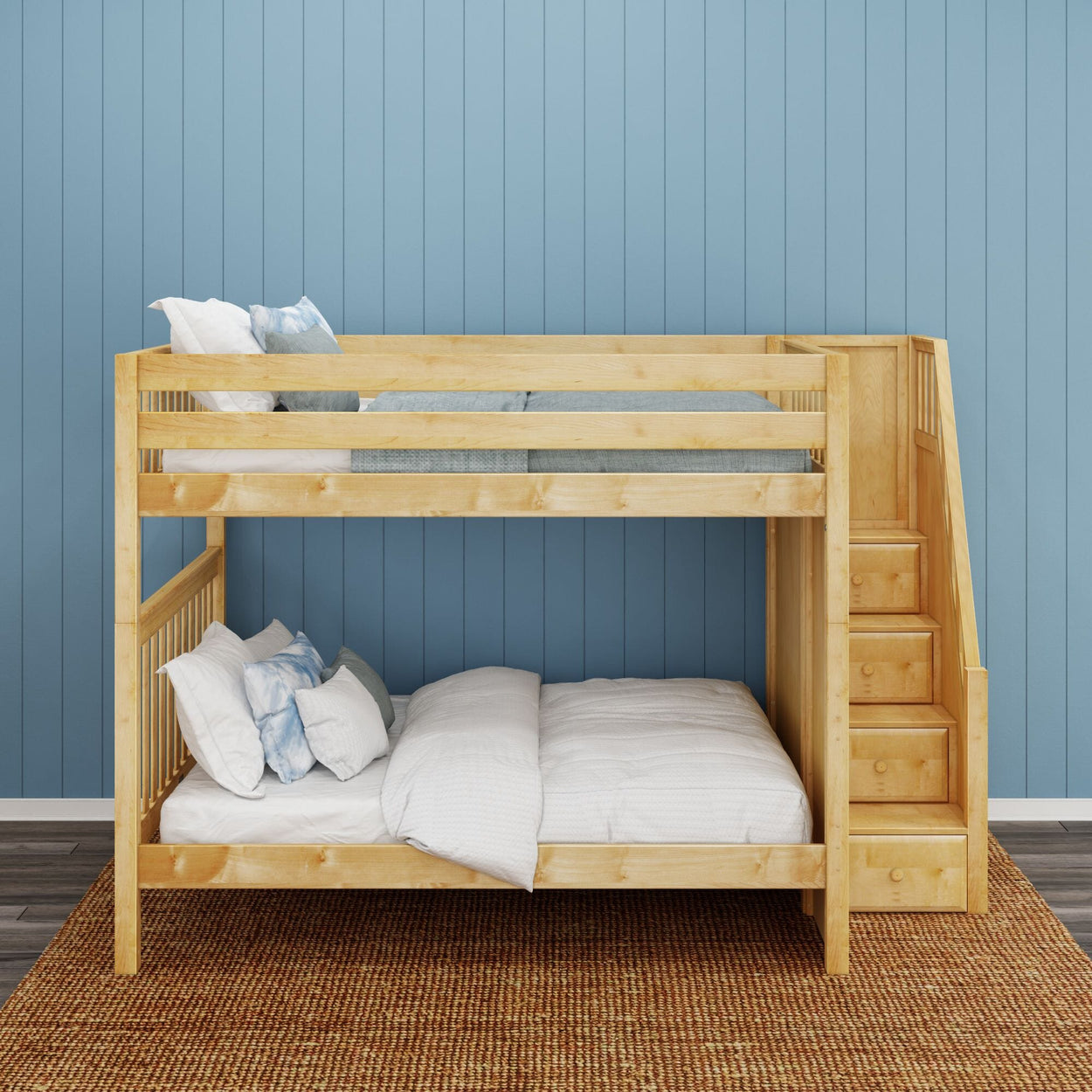 Wooden bunk bed with staircase in a cozy room with blue paneled walls.