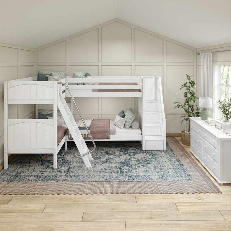 White bunk beds with staircase storage in a farmhouse-style shared kids' bedroom featuring a board-and-batten accent wall, soft pink quilts, patterned rug, white dresser and natural light