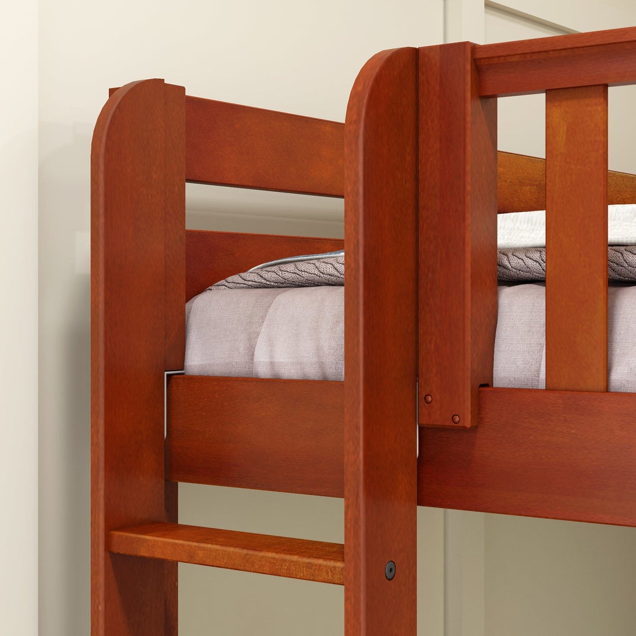 Wooden bunk bed corner with mattress and beige wall background.