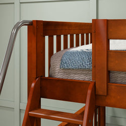 Wooden bunk bed with metal ladder and cozy bedding in modern bedroom.