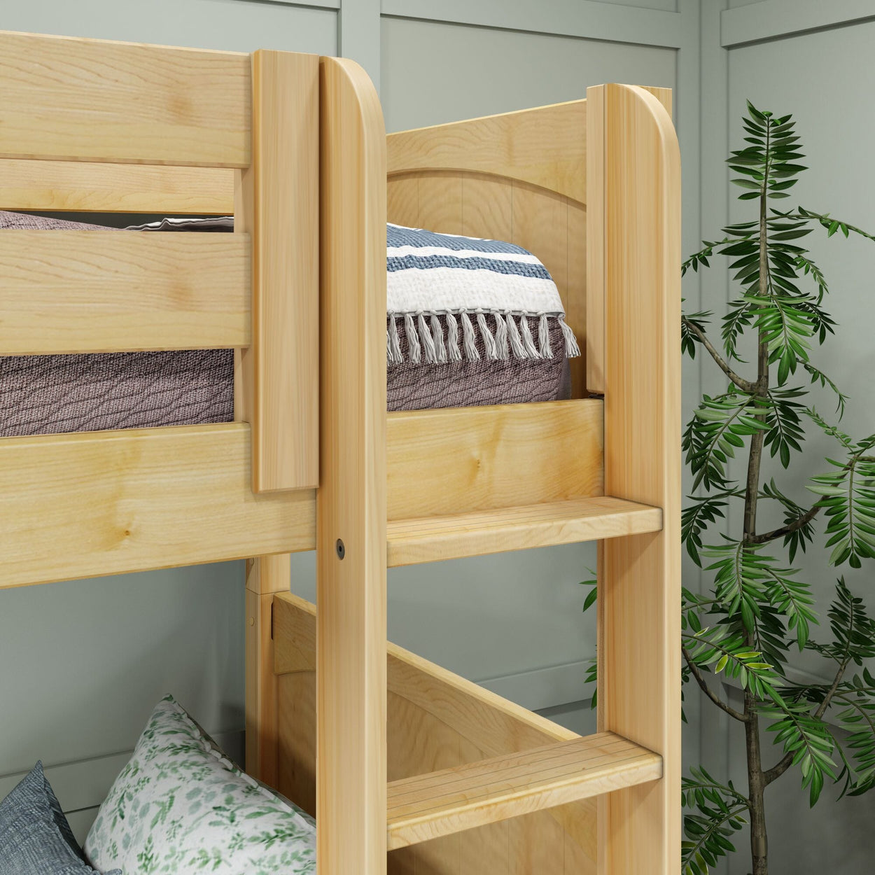 Wooden bunk bed frame with ladder and bedding in a cozy room setting.