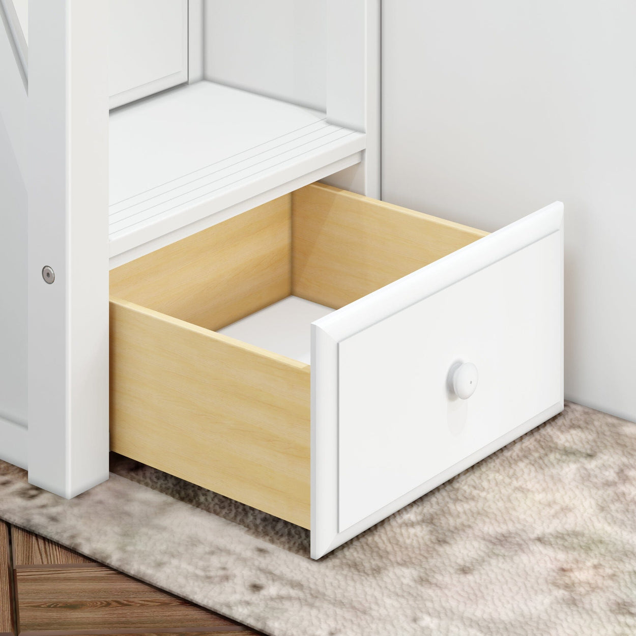 Open white wood drawer showing light wood interior, placed on a textured carpeted floor for stylish home storage solutions.
