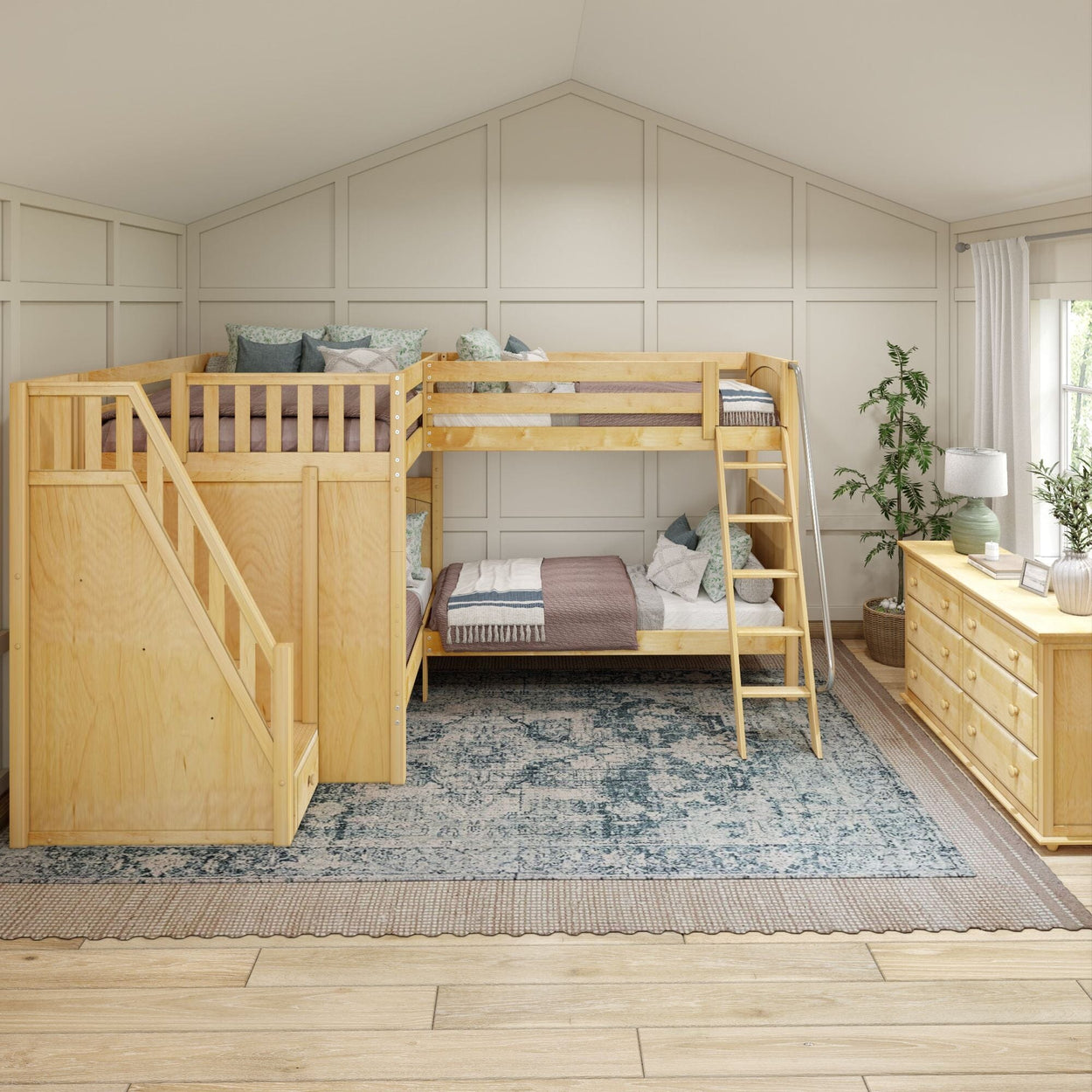 Wooden bunk bed with stairs and storage in a cozy, light-filled kids' bedroom with a stylish rug and dresser.