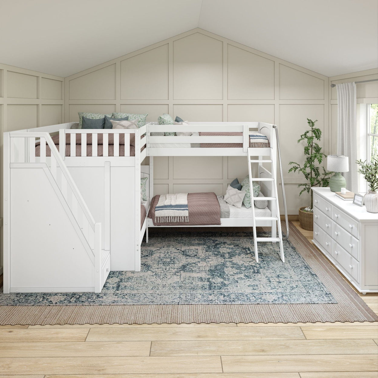 White loft bunk bed with stairs in a cozy, modern bedroom featuring a dresser and potted plant.
