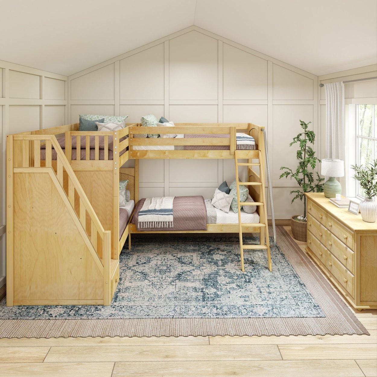 Natural wood bunk bed with staircase in a cozy, light-filled bedroom featuring a patterned rug and dresser.