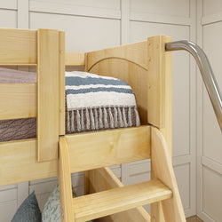 Wooden bunk bed with striped blanket and built-in slide in modern bedroom.
