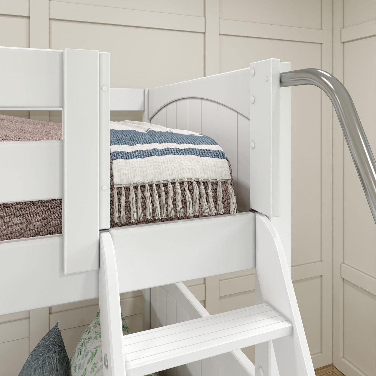 White bunk bed corner with blue and white striped blanket and modern slide in a stylish kids' bedroom.
