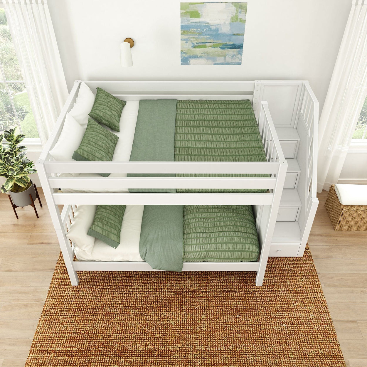White bunk bed with green bedding and built-in stairs in a bright, modern bedroom.