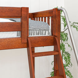 Wooden bunk bed with a silver slide, cozy gray blanket, and decorative plant in a modern bedroom setting.