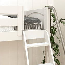 White loft bed with ladder and black patterned blanket in a modern bedroom setting.
