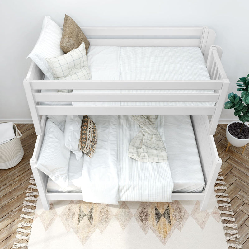 Top-down view of a white wooden bunk bed with crisp white linens, neutral throw pillows, checkered blanket and potted plant in a modern kids' bedroom
