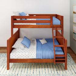 Wooden bunk bed with blue and white bedding on a striped rug in a modern bedroom setting.