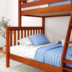 Wooden bunk bed with blue bedding and star-patterned sheets in a bright minimalist bedroom setting.