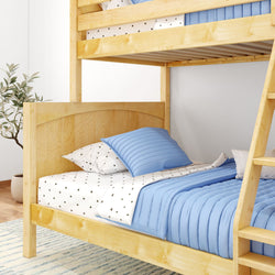 Wooden bunk bed with blue bedding and white star-patterned sheets in a cozy bedroom setting.