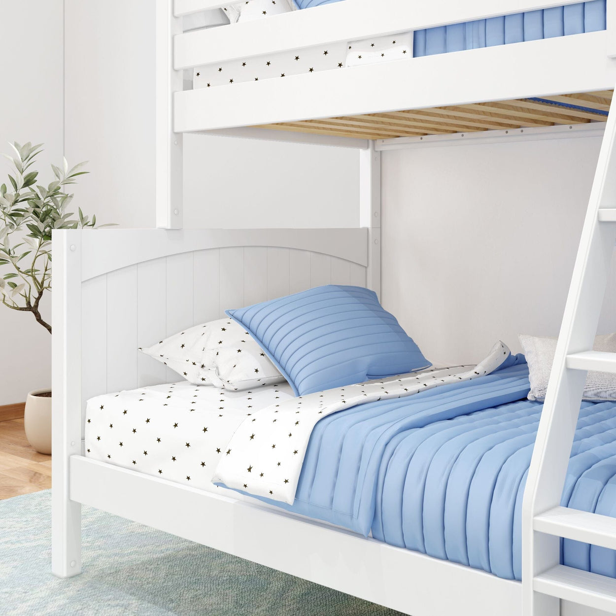White wooden bunk bed with blue bedding and star-patterned pillows in a cozy bedroom setup.
