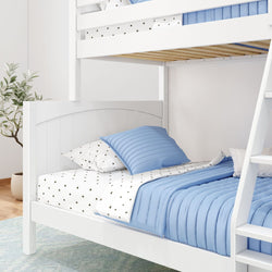White wooden bunk bed with blue bedding and star-patterned pillows in a cozy bedroom setup.