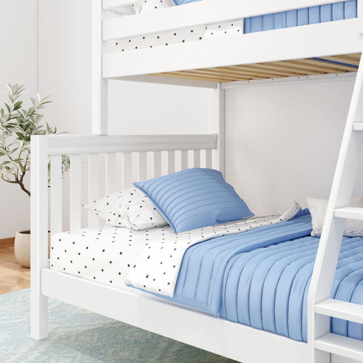 White bunk bed with blue bedding and polka dot sheets in a bright modern bedroom.
