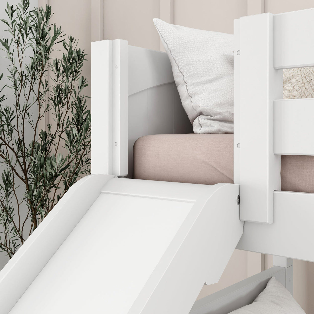 White children's loft bed with slide and pink bedding, featuring beige pillows and a decorative plant, ideal for modern kid's room design.