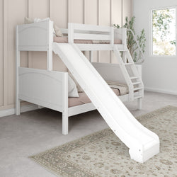 White wooden bunk bed with slide in a stylish bedroom featuring soft pillows and a decorative rug.