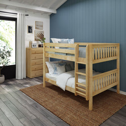 Wooden bunk bed in modern bedroom with blue accent wall and wooden dresser.