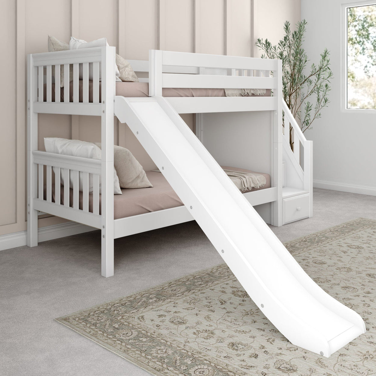 White wooden bunk bed with slide and stairs in a cozy children's bedroom featuring soft pillows and a patterned floor rug.
