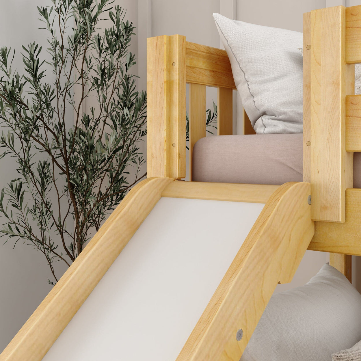 Wooden loft bed with integrated slide and neutral bedding in a modern kid's room with a potted plant.