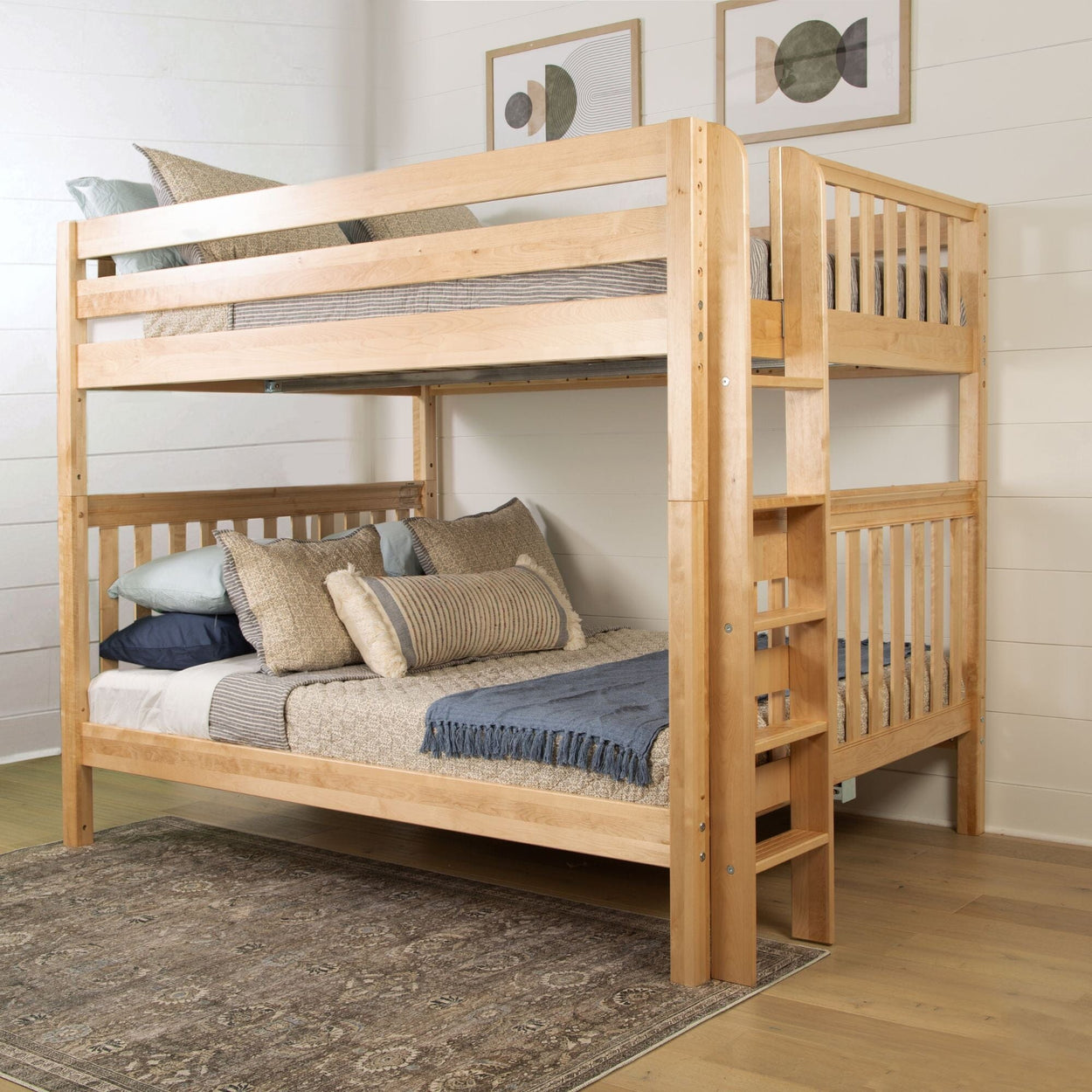 Wooden bunk bed with cozy bedding and a decorative rug in a stylish bedroom.