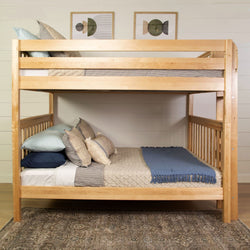 Wooden bunk bed with comfortable bedding and pillows in a modern bedroom setting.