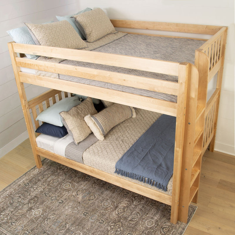 Light natural wood twin-over-full bunk bed with blue and beige bedding and decorative pillows, space-saving bedroom furniture