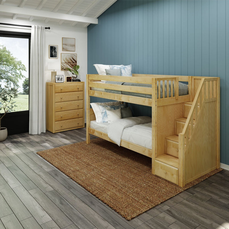 Wooden bunk bed with stairs in bright kids' bedroom with blue vertical accent wall, natural wood dresser, white curtains and woven rug