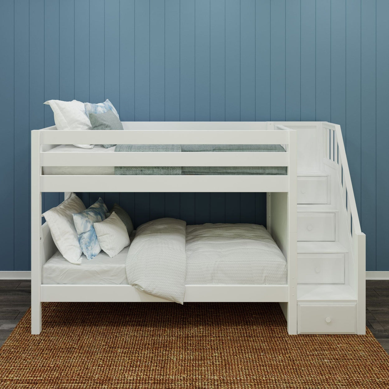 White wooden bunk bed with stairs, cozy bedding, blue wall background, and woven rug.