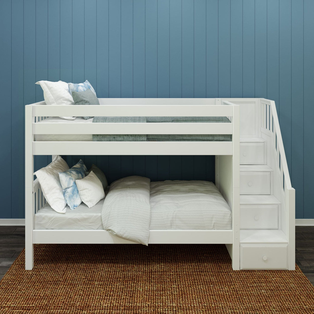 White wooden bunk bed with stairs and bedding against a blue paneled wall.