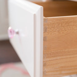 Open wooden drawer with dovetail joints showcasing craftsmanship in furniture design.