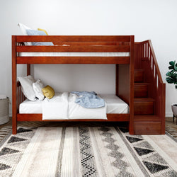 Rustic wooden bunk bed with staircase and cozy bedding in a modern bedroom setting.