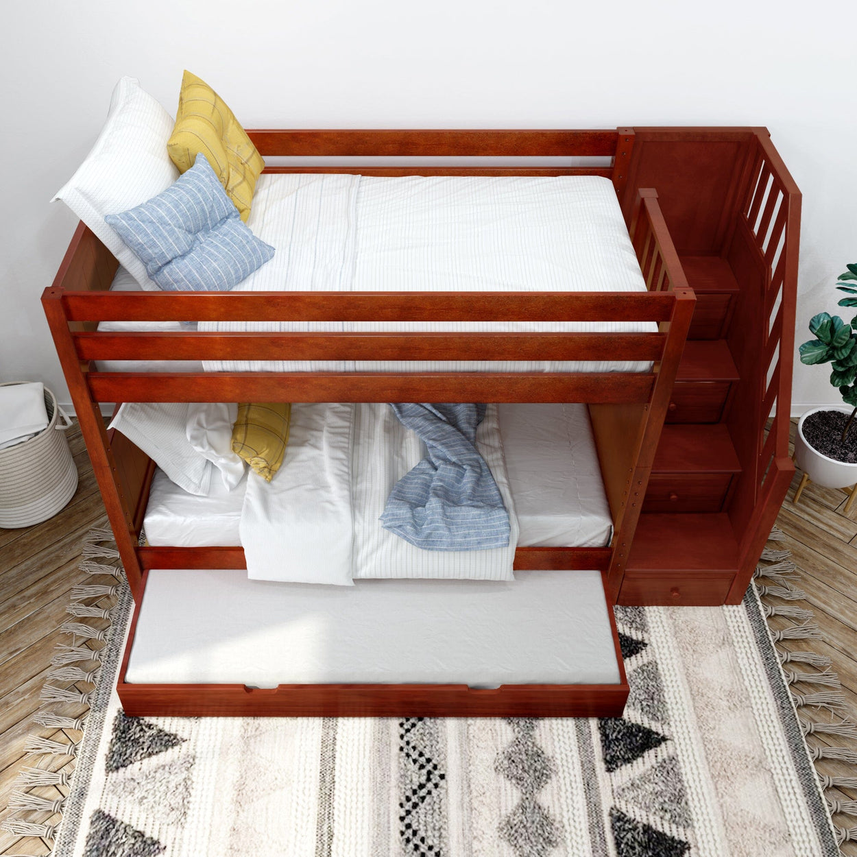 Wooden bunk bed with stairs and trundle, featuring white and blue bedding, in a modern bedroom setting.