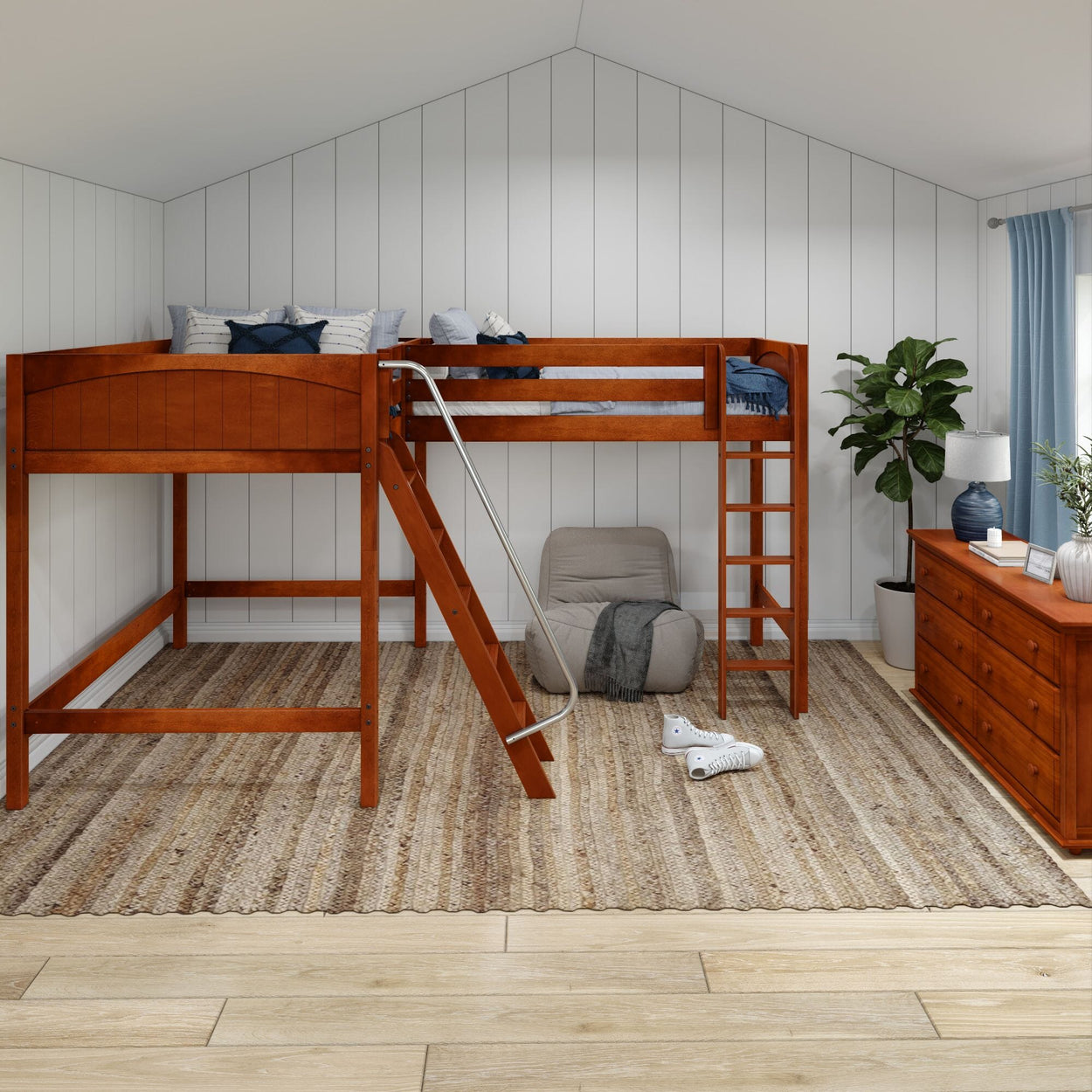 Cozy loft bedroom with wooden loft bed, ladder, and soft seating, featuring natural decor and a chest of drawers with a lamp for a modern interior design.
