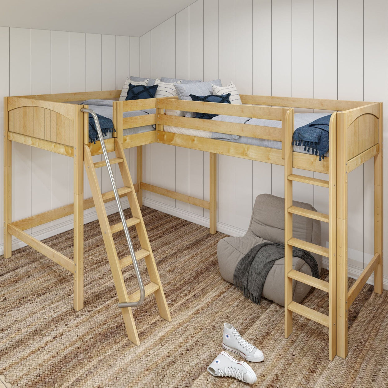 Wooden corner loft bed with ladder, styled with blue and white bedding, in a cozy room with beige rug and a bean bag chair.