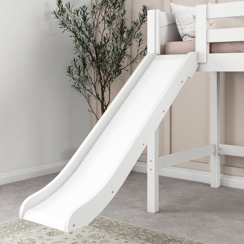 White wooden kids loft bed with slide, blush mattress and pillows and decorative indoor plant in a modern neutral bedroom