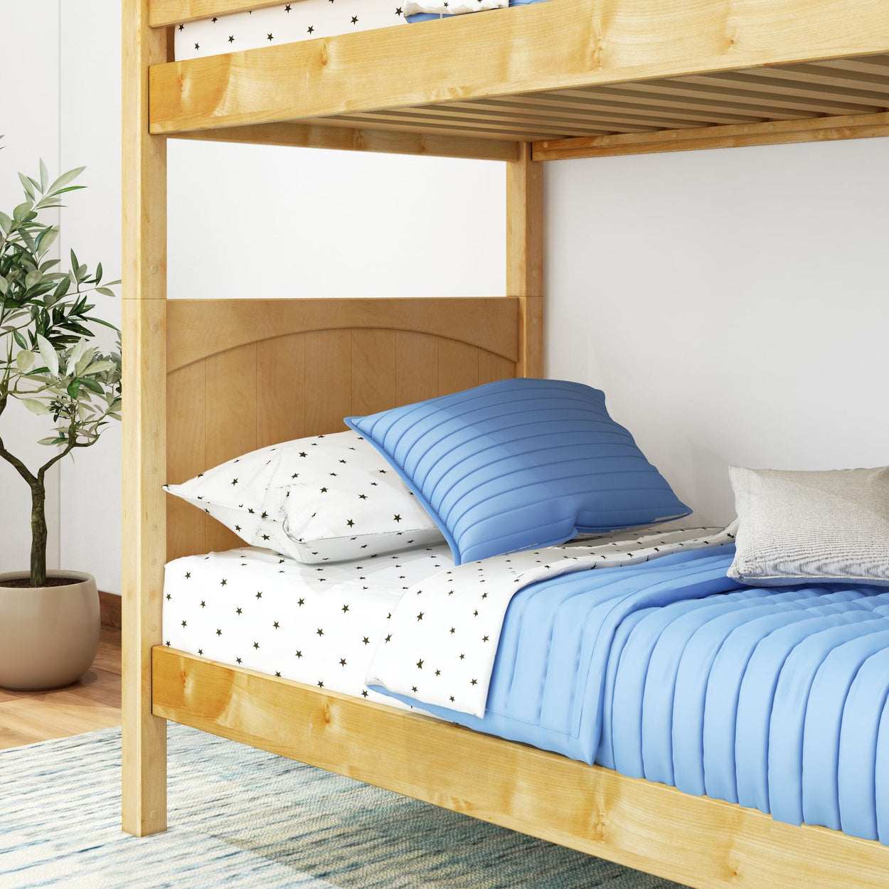Wooden bunk bed with blue and star-patterned bedding in a cozy bedroom setting.