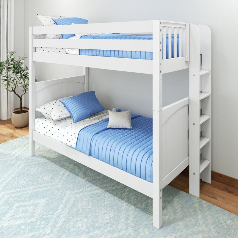 White twin-over-twin wooden bunk bed with blue quilted bedding, star-pattern sheets, safety rails and ladder in a bright modern kids' bedroom with potted plant