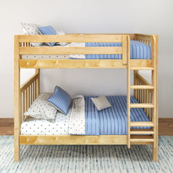 Wooden bunk bed with blue bedding and polka dot sheets in a modern bedroom setting.