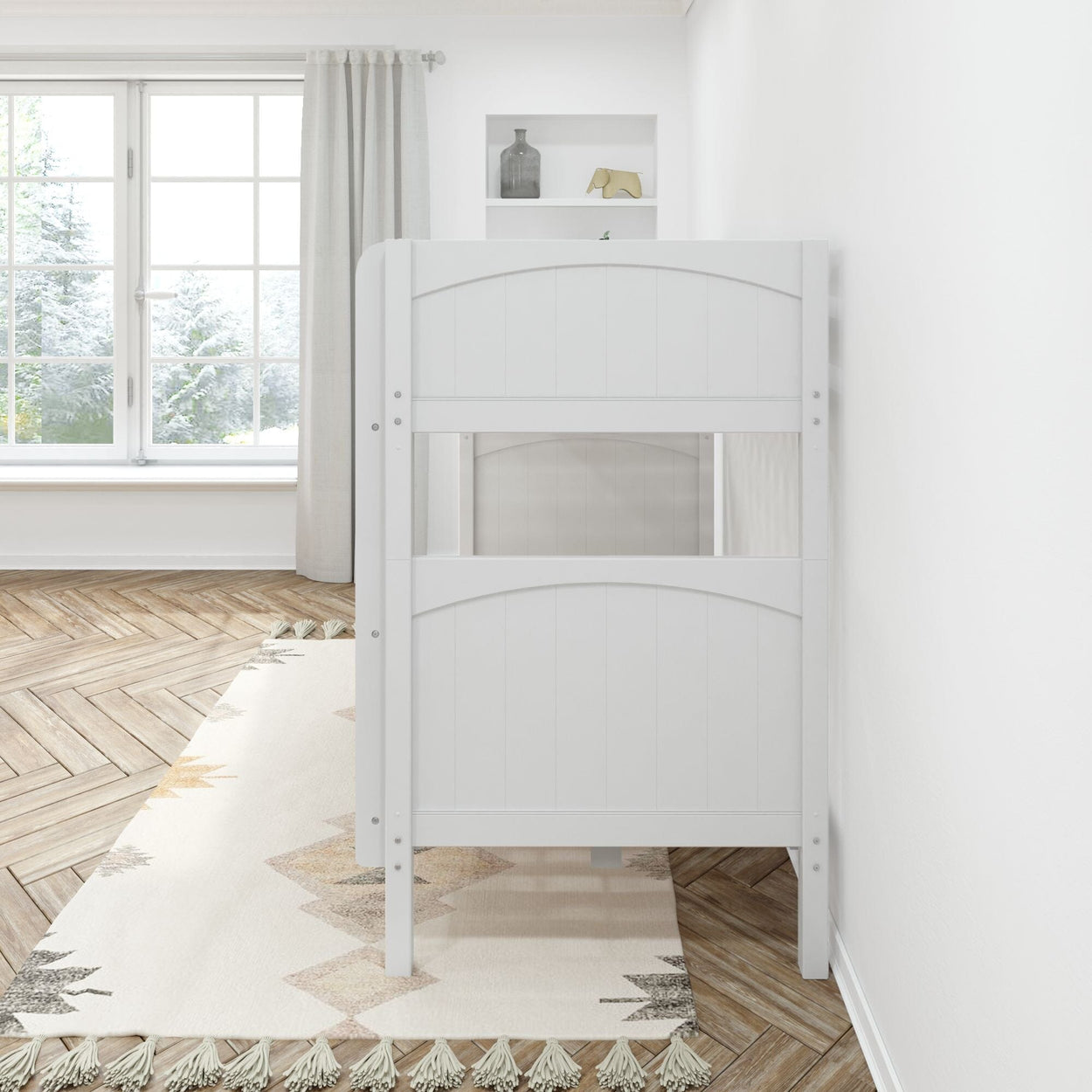 Side view of a modern white bunk bed with a patterned rug and large window in a bright bedroom.