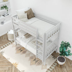 White wooden bunk bed in a modern bedroom with decorative pillows, a geometric patterned rug, and indoor plants.