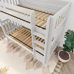 White wooden bunk bed with ladder and slatted base, situated on a geometric-patterned rug next to a potted plant.