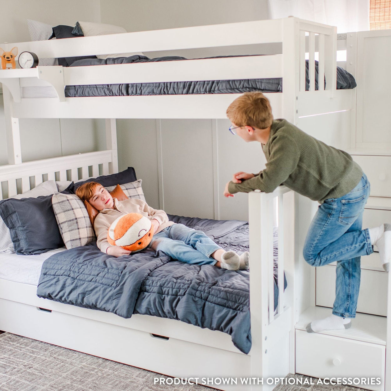 Kids playing on a white bunk bed in a cozy bedroom setting with a plush toy.