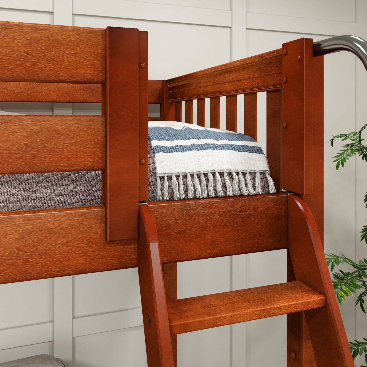 Wooden bunk bed with striped blanket and ladder in a cozy bedroom setting.