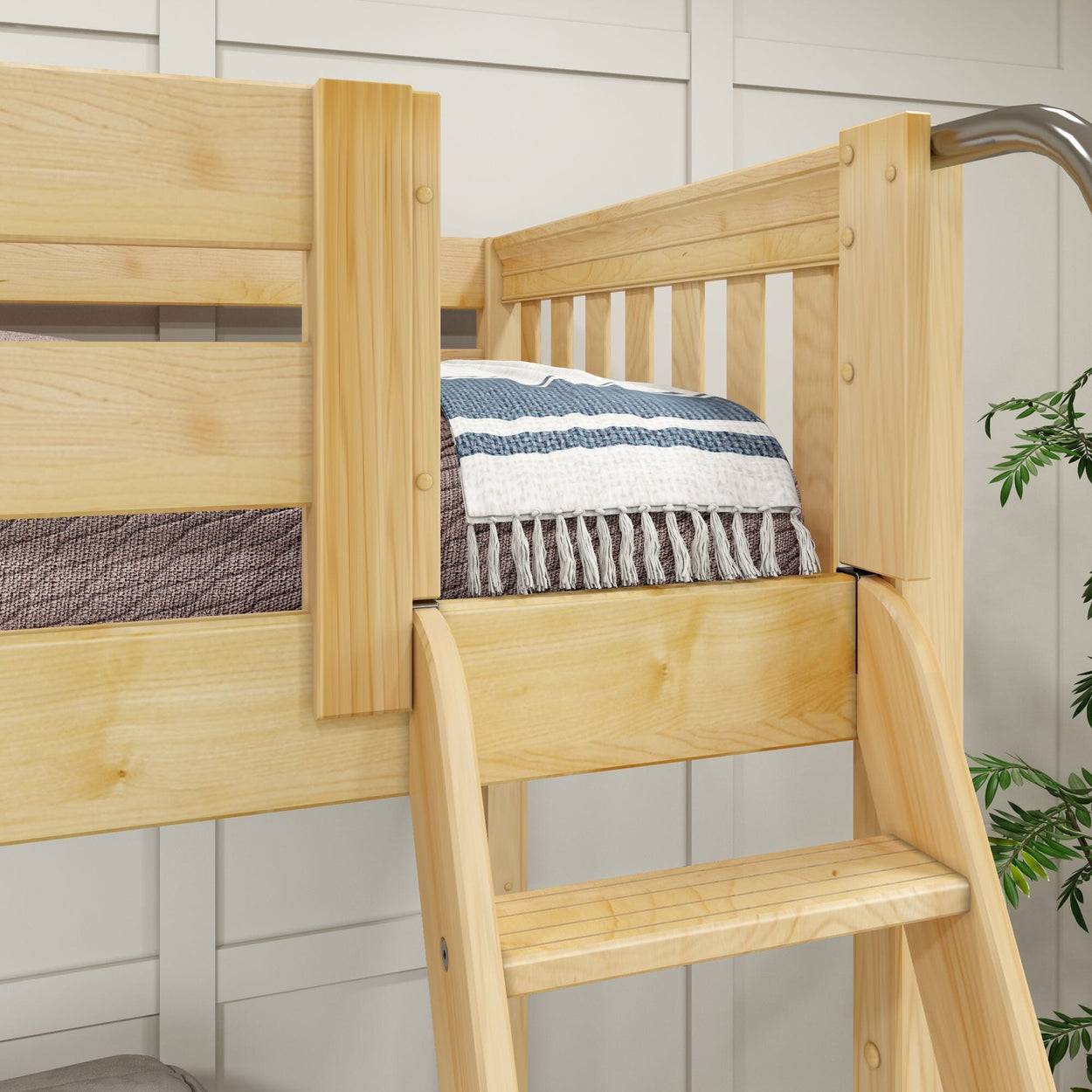 Wooden bunk bed with a blue and white striped blanket, highlighting modern bedroom furniture design.